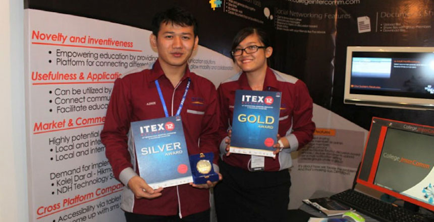 The winners showing off their medals at their exhibition booth at ITEX 2012