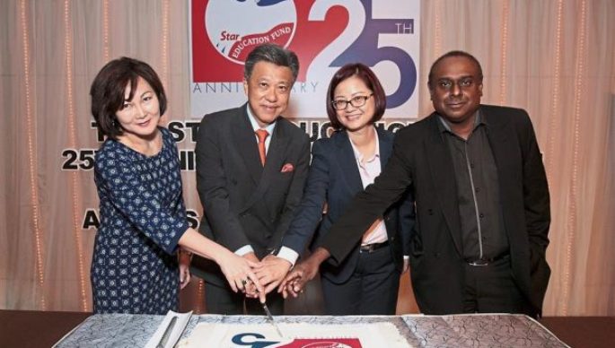 (From left) June, Wong, Wang and Terence cutting the 25th anniversary cake.